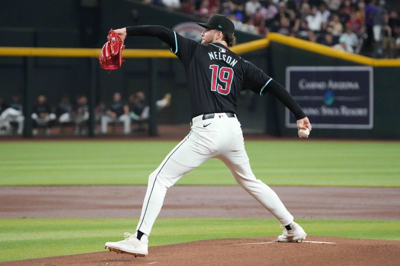 Jul 12, 2024; Phoenix, Arizona, USA; Arizona Diamondbacks pitcher Ryne Nelson (19) pitches against the Toronto Blue Jays during the first inning at Chase Field. Mandatory Credit: Joe Camporeale-USA TODAY Sports