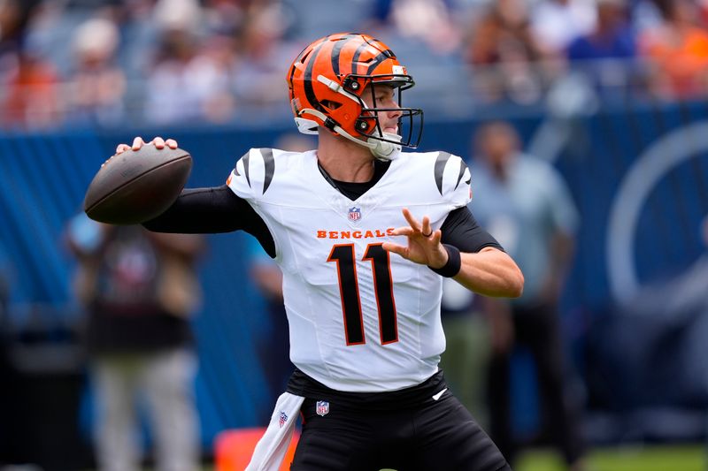 Cincinnati Bengals quarterback Logan Woodside (11) prepares to throw the ball during the first half of an NFL preseason football game against the Chicago Bears, Saturday, Aug. 17, 2024, at Soldier Field in Chicago. (AP Photo/Charles Rex Arbogast)