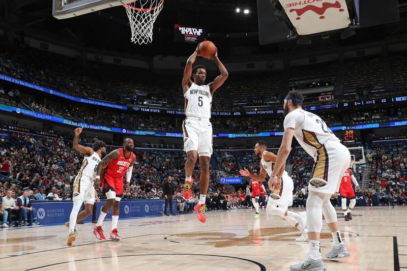 NEW ORLEANS, LA - FEBRUARY 22:  Herb Jones #5 of the New Orleans Pelicans grabs a rebound during the game against the Houston Rockets on February 22, 2024 at the Smoothie King Center in New Orleans, Louisiana. NOTE TO USER: User expressly acknowledges and agrees that, by downloading and or using this Photograph, user is consenting to the terms and conditions of the Getty Images License Agreement. Mandatory Copyright Notice: Copyright 2024 NBAE (Photo by Layne Murdoch Jr./NBAE via Getty Images)