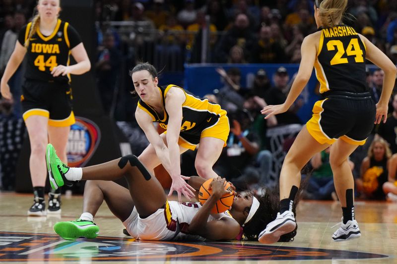 Apr 7, 2024; Cleveland, OH, USA; South Carolina Gamecocks guard Raven Johnson (25) fights for a loose ball against Iowa Hawkeyes guard Caitlin Clark (22) in the second quarter in the finals of the Final Four of the womens 2024 NCAA Tournament at Rocket Mortgage FieldHouse. Mandatory Credit: Kirby Lee-USA TODAY Sports