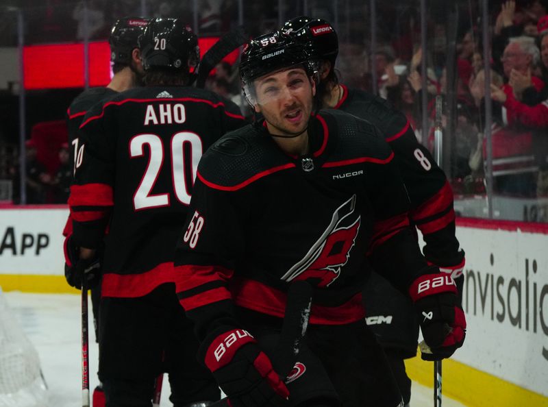 Jan 21, 2024; Raleigh, North Carolina, USA;  Carolina Hurricanes left wing Michael Bunting (58) celebrates his goal against the Minnesota Wild during the third period at PNC Arena. Mandatory Credit: James Guillory-USA TODAY Sports