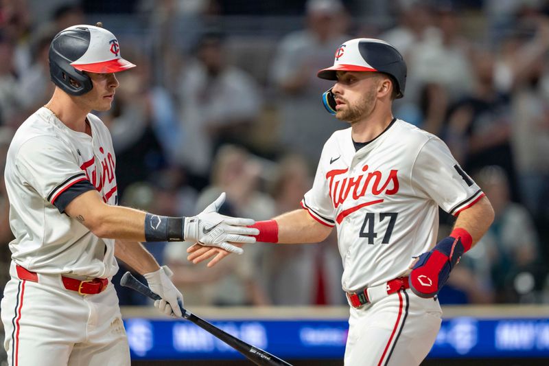 May 8, 2024; Minneapolis, Minnesota, USA; Minnesota Twins second baseman Edouard Julien (47) celebrates with right fielder Max Kepler (26) after scoring a run against the Seattle Mariners in the eighth inning at Target Field. Mandatory Credit: Jesse Johnson-USA TODAY Sports