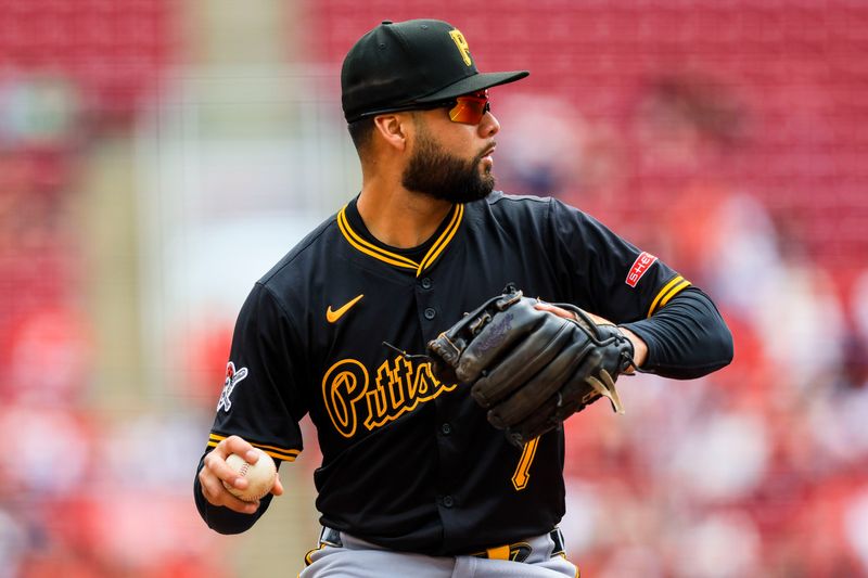 Apr 13, 2025; Cincinnati, Ohio, USA; Pittsburgh Pirates third baseman Isiah Kiner-Falefa (7) throws to first to get Cincinnati Reds second baseman Santiago Espinal (not pictured) in the first inning at Great American Ball Park. Mandatory Credit: Katie Stratman-Imagn Images