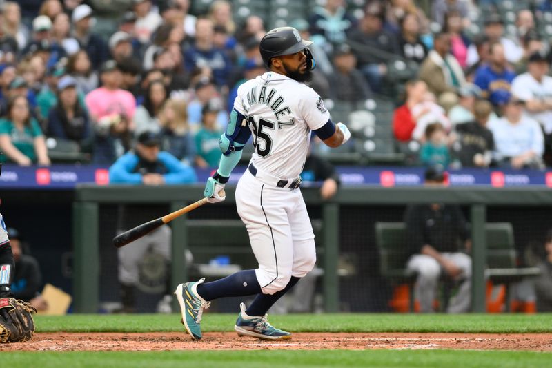 Jun 14, 2023; Seattle, Washington, USA; Seattle Mariners right fielder Teoscar Hernandez (35) hits a double against the Miami Marlins during the fourth inning at T-Mobile Park. Mandatory Credit: Steven Bisig-USA TODAY Sports