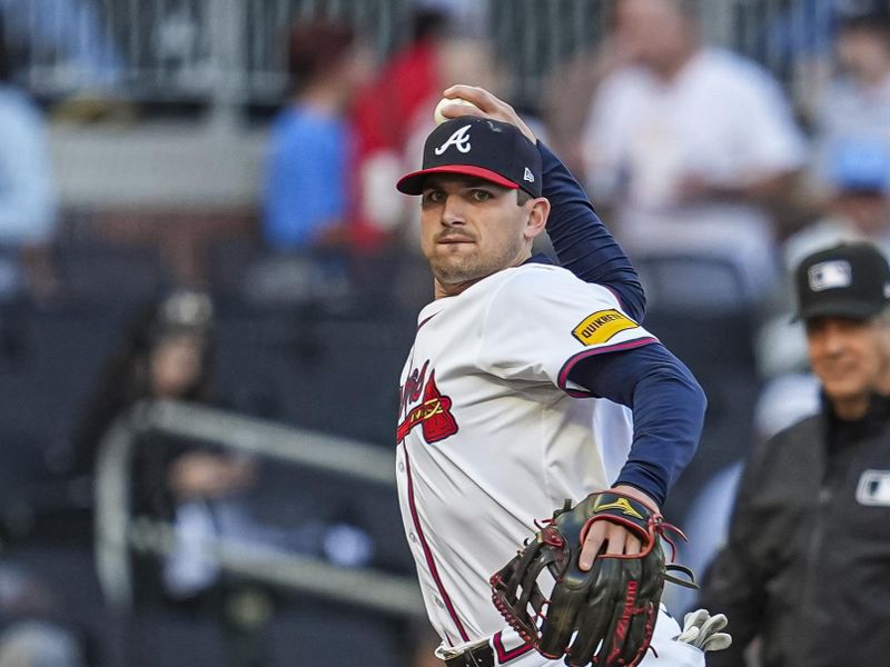 Apr 23, 2024; Cumberland, Georgia, USA; Atlanta Braves third base Austin Riley (27)  throws out Miami Marlins designated hitter  Josh Bell (9) (not shown) after fielding a ground ball during the first inning at Truist Park. Mandatory Credit: Dale Zanine-USA TODAY Sports