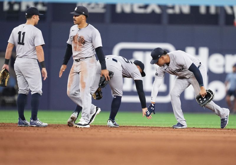 Jun 30, 2024; Toronto, Ontario, CAN; New York Yankees right fielder Juan Soto (22) celebrates the win with New York Yankees second baseman Gleyber Torres (25) against the Toronto Blue Jays at the end of the ninth inning at Rogers Centre. Mandatory Credit: Nick Turchiaro-USA TODAY Sports