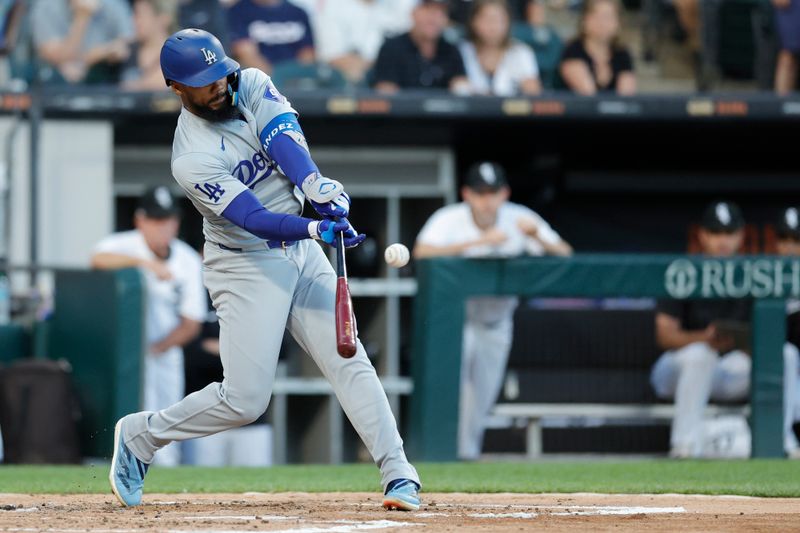 Jun 26, 2024; Chicago, Illinois, USA; Los Angeles Dodgers outfielder Teoscar Hernández (37) hits an RBI-sacrifice fly against the Chicago White Sox during the third inning at Guaranteed Rate Field. Mandatory Credit: Kamil Krzaczynski-USA TODAY Sports