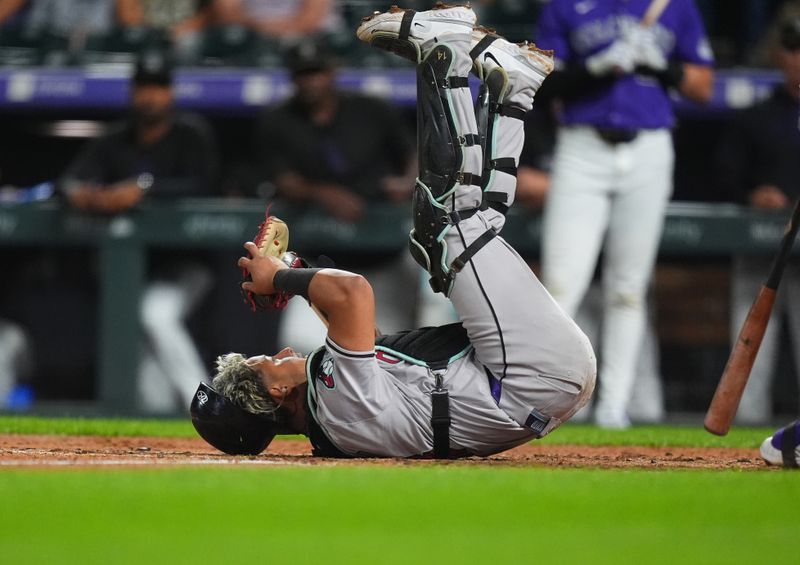 Sep 16, 2024; Denver, Colorado, USA; Arizona Diamondbacks catcher Gabriel Moreno (14) makes a foul ball catch in the fifth inning against the Colorado Rockies at Coors Field. Mandatory Credit: Ron Chenoy-Imagn Images