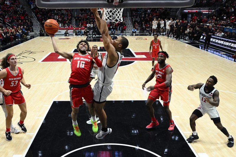 Jan 14, 2023; San Diego, California, USA; New Mexico Lobos guard Jaelen House (10) goes to the basket while defended by San Diego State Aztecs forward Jaedon LeDee (13) during the second half at Viejas Arena. Mandatory Credit: Orlando Ramirez-USA TODAY Sports