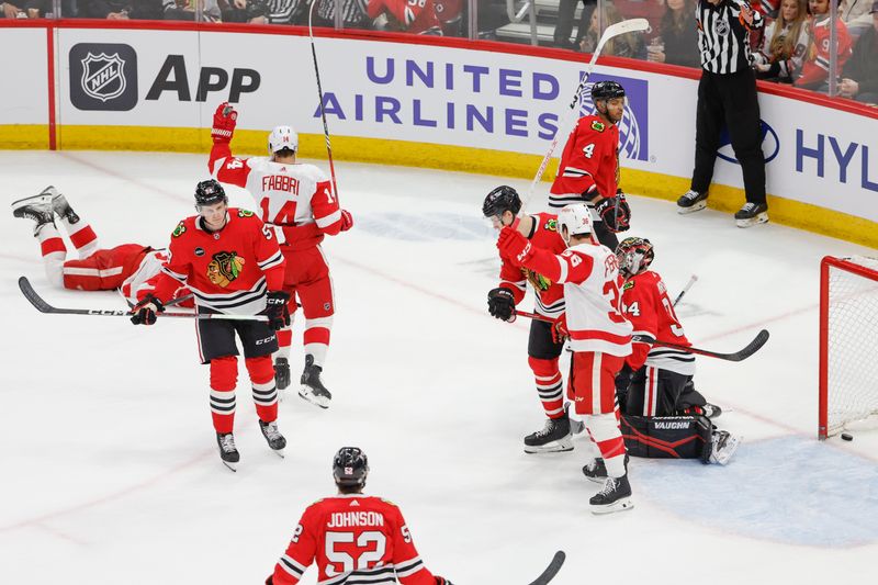 Feb 25, 2024; Chicago, Illinois, USA; Detroit Red Wings right wing Daniel Sprong (L) scores against the Chicago Blackhawks during the first period at United Center. Mandatory Credit: Kamil Krzaczynski-USA TODAY Sports