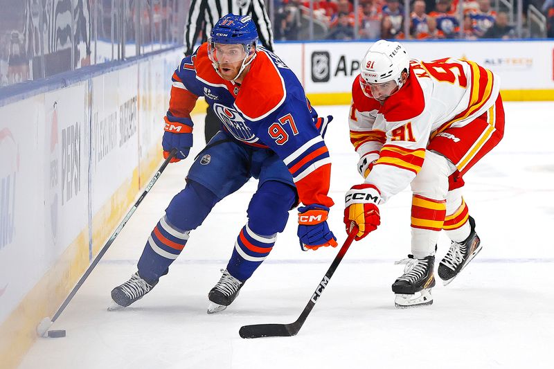 Oct 8, 2025; Edmonton, Alberta, CAN; Edmonton Oilers forward Connor McDavid (97) carries the puck around Calgary Flames forward Name Kadri (91) during the first period at Rogers Place. Mandatory Credit: Perry Nelson-Imagn Images