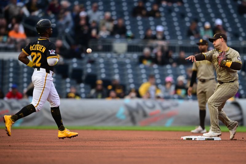 May 3, 2025; Pittsburgh, Pennsylvania, USA; San Diego Padres first baseman Luis Arraez (4) throws to first after forcing out Pittsburgh Pirates right fielder Andrew McCutchen (22) during the fifth inning at PNC Park. Mandatory Credit: David Dermer-Imagn Images
