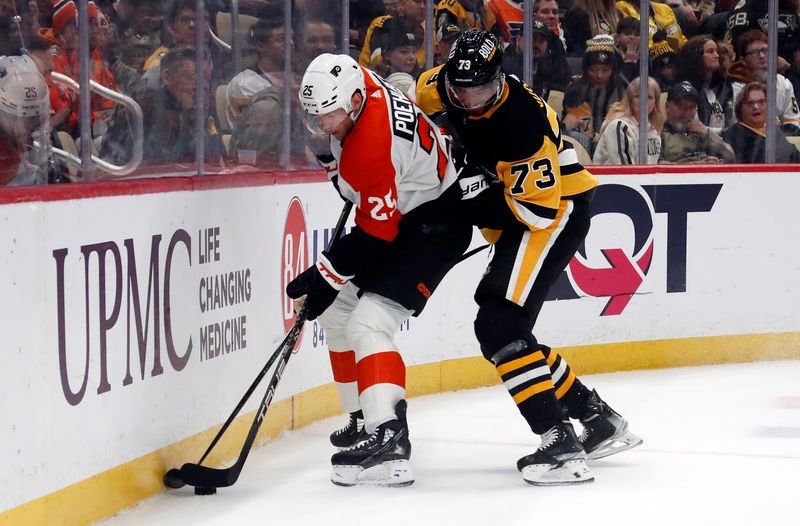 Feb 25, 2024; Pittsburgh, Pennsylvania, USA;  Philadelphia Flyers center Ryan Poehling (25) moves the puck against pressure from Pittsburgh Penguins defenseman Pierre-Olivier Joseph (73) during the first period at PPG Paints Arena. Mandatory Credit: Charles LeClaire-USA TODAY Sports