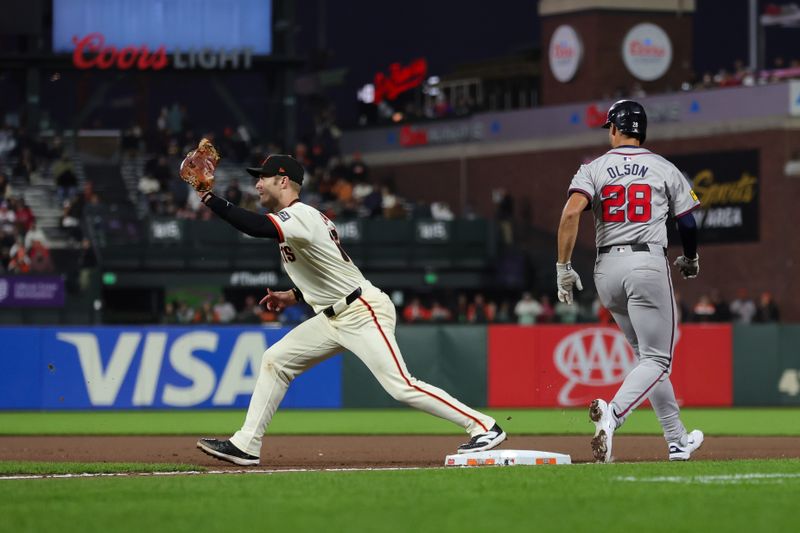 Aug 12, 2024; San Francisco, California, USA; San Francisco Giants first base Mark Canha (16) stretches for the ball during the seventh inning against the Atlanta Braves at Oracle Park. Mandatory Credit: Sergio Estrada-USA TODAY Sports