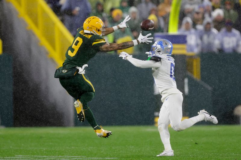 Green Bay Packers wide receiver Christian Watson (9) makes a catch next to Detroit Lions cornerback Terrion Arnold (0) during the second half of an NFL football game Sunday, Nov. 3, 2024, in Green Bay, Wis. (AP Photo/Matt Ludtke)