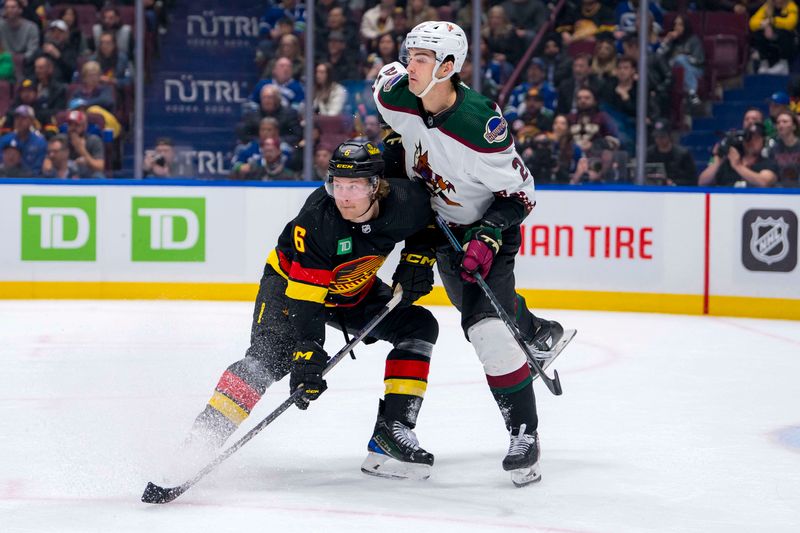 Apr 10, 2024; Vancouver, British Columbia, CAN; Arizona Coyotes forward Jack McBain (22) battles with Vancouver Canucks forward Brock Boeser (6) in the third period at Rogers Arena. Arizona won 4-3 in overtime. Mandatory Credit: Bob Frid-USA TODAY Sports