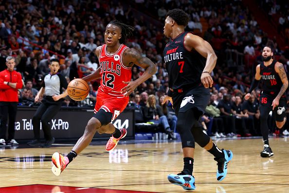 MIAMI, FLORIDA - DECEMBER 16: Ayo Dosunmu #12 of the Chicago Bulls drives against Kyle Lowry #7 of the Miami Heat during the third quarter of the game at Kaseya Center on December 16, 2023 in Miami, Florida. NOTE TO USER: User expressly acknowledges and agrees that, by downloading and or using this photograph, User is consenting to the terms and conditions of the Getty Images License Agreement. (Photo by Megan Briggs/Getty Images)