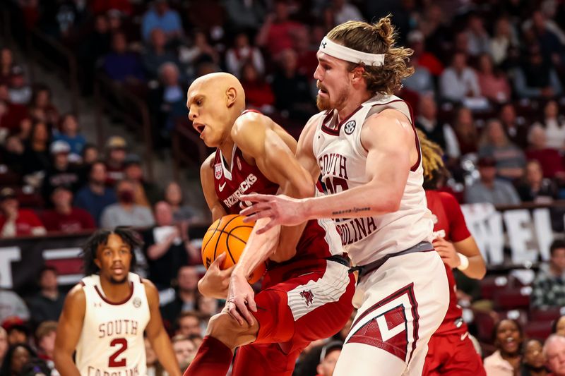 Feb 4, 2023; Columbia, South Carolina, USA; Arkansas Razorbacks guard Jordan Walsh (13) and South Carolina Gamecocks forward Hayden Brown (10) battle for a rebound in the second half at Colonial Life Arena. Mandatory Credit: Jeff Blake-USA TODAY Sports