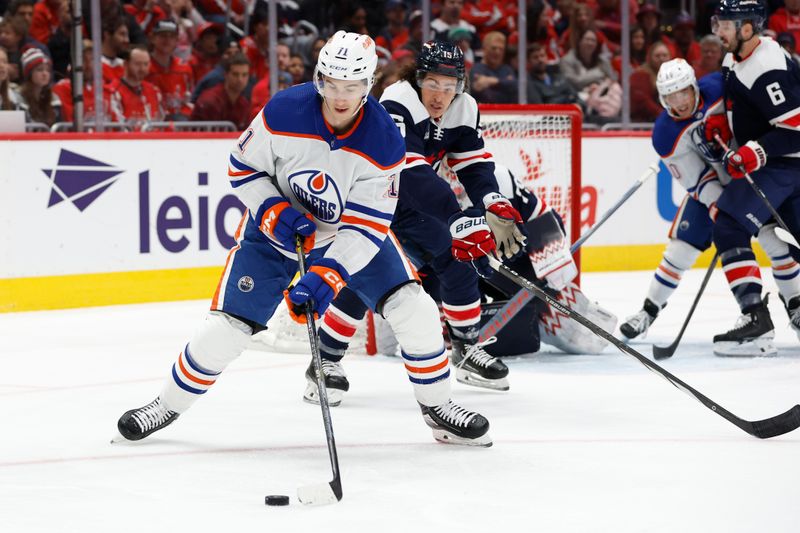 Nov 24, 2023; Washington, District of Columbia, USA; Edmonton Oilers center Ryan McLeod (71) skates with the puck as Washington Capitals left wing Sonny Milano (15) defends in the second period at Capital One Arena. Mandatory Credit: Geoff Burke-USA TODAY Sports