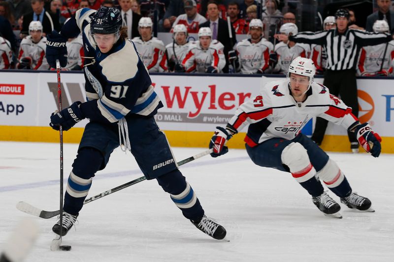 Dec 21, 2023; Columbus, Ohio, USA; Columbus Blue Jackets left wing Kent Johnson (91) skates away from Washington Capitals left wing Beck Malenstyn (47) during the first period at Nationwide Arena. Mandatory Credit: Russell LaBounty-USA TODAY Sports