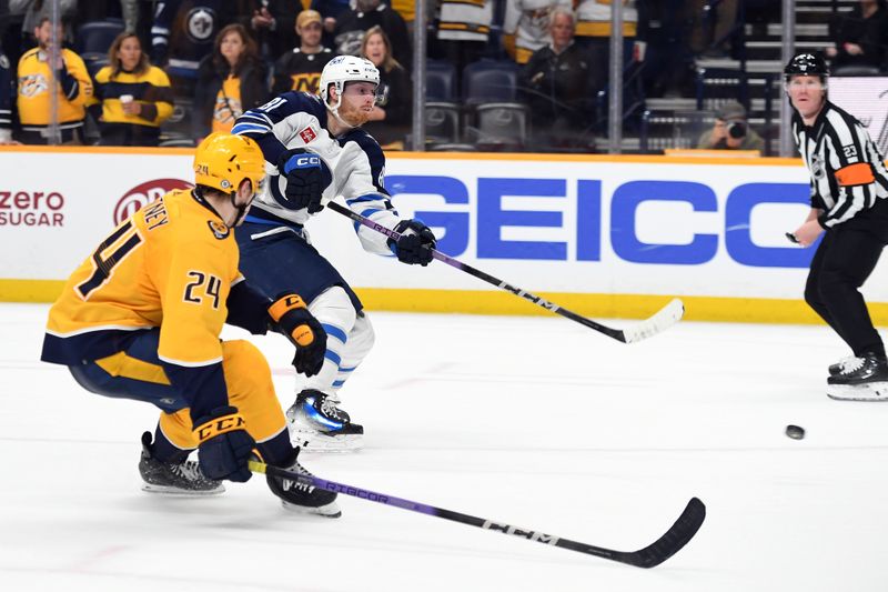 Apr 9, 2024; Nashville, Tennessee, USA; Winnipeg Jets left wing Kyle Connor (81) scores in overtime to win against the Nashville Predators at Bridgestone Arena. Mandatory Credit: Christopher Hanewinckel-USA TODAY Sports