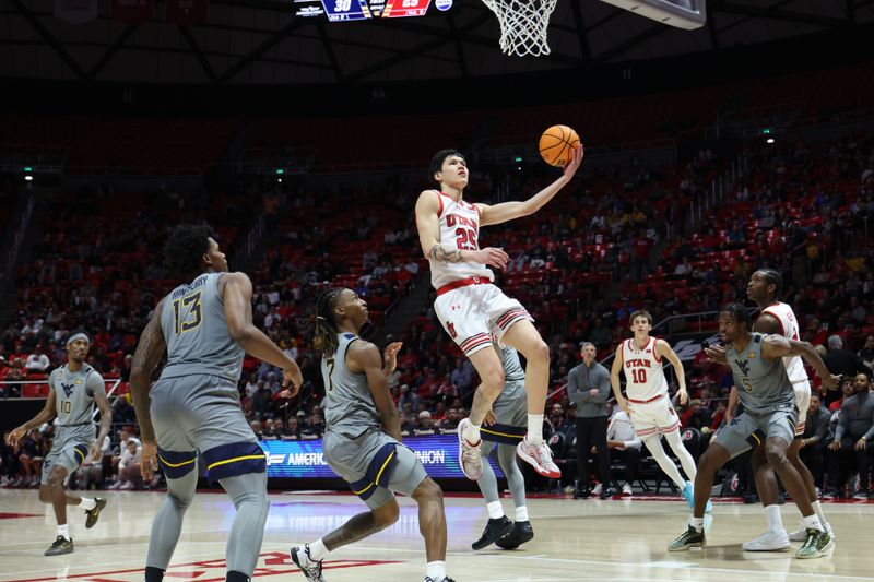 Mar 4, 2025; Salt Lake City, Utah, USA; Utah Utes guard Mike Sharavjamts (25) lays the ball up against the West Virginia Mountaineers during the second half at Jon M. Huntsman Center. Mandatory Credit: Rob Gray-Imagn Images