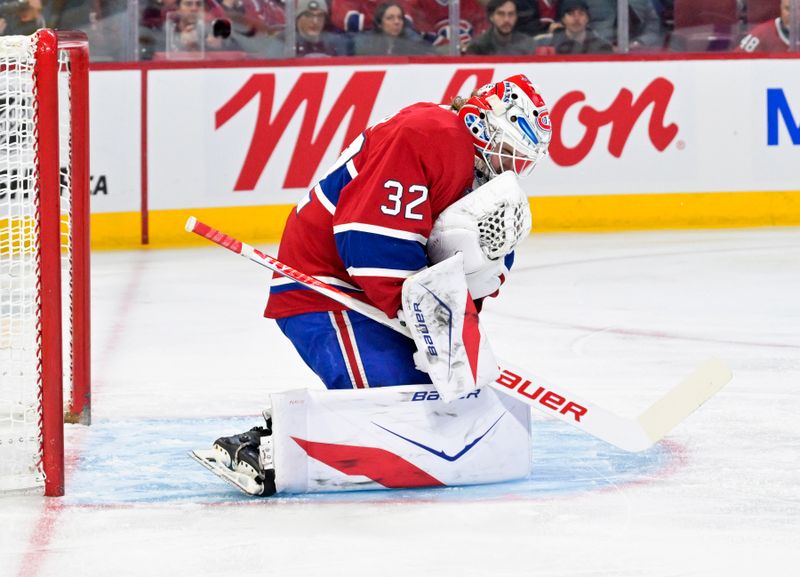 Jan 7, 2026; Montreal, Quebec, CAN; Montreal Canadiens goalie Jacob Fowler (32) covers up the puck during the first period of the game against the Calgary Flames at the Bell Centre. Mandatory Credit: Eric Bolte-Imagn Images
