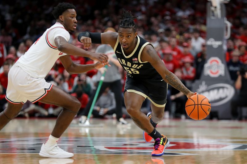 Feb 18, 2024; Columbus, Ohio, USA;  Purdue Boilermakers guard Lance Jones (55) dribbles the ball as Ohio State Buckeyes guard Dale Bonner (4) defends during the first half at Value City Arena. Mandatory Credit: Joseph Maiorana-USA TODAY Sports