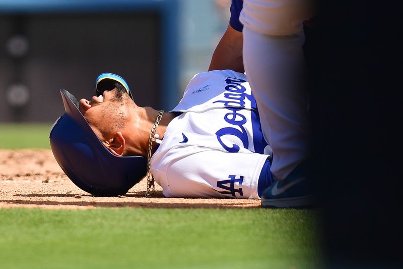 Jun 16, 2024; Los Angeles, California, USA; Los Angeles Dodgers shortstop Mookie Betts (50) reacts after being hit by pitch from Kansas City Royals pitcher Dan Altavilla (54) during the seventh inning at Dodger Stadium. Mandatory Credit: Gary A. Vasquez-USA TODAY Sports