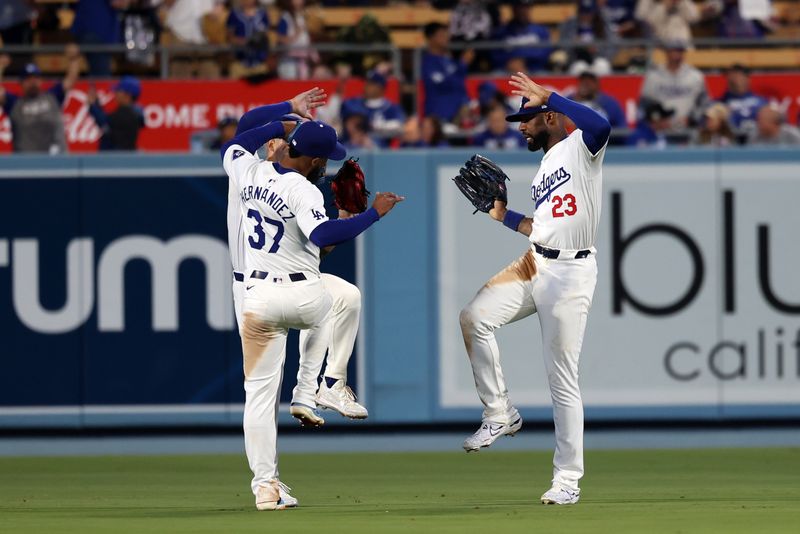 Jun 1, 2024; Los Angeles, California, USA;  Los Angeles Dodgers center fielder Andy Pages (44) and left fielder Teoscar Hernandez (37) and right fielder Jason Heyward (23)celebrate a victory after defeating the Colorado Rockies 4-1 at Dodger Stadium. Mandatory Credit: Kiyoshi Mio-USA TODAY Sports