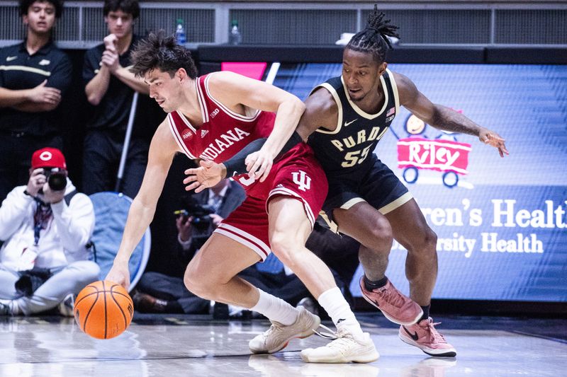 Feb 10, 2024; West Lafayette, Indiana, USA; Indiana Hoosiers guard Trey Galloway (32) dribbles the ball while  Purdue Boilermakers guard Lance Jones (55) defends in the second half at Mackey Arena. Mandatory Credit: Trevor Ruszkowski-USA TODAY Sports