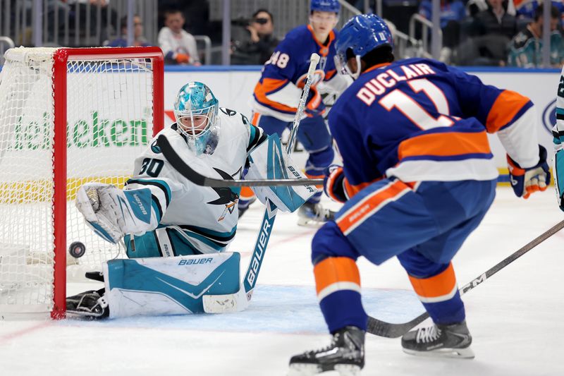 Oct 21, 2025; Elmont, New York, USA; San Jose Sharks goaltender Yaroslav Askarov (30) makes a save against New York Islanders left wing Anthony Duclair (11) during the second period at UBS Arena. Mandatory Credit: Brad Penner-Imagn Images