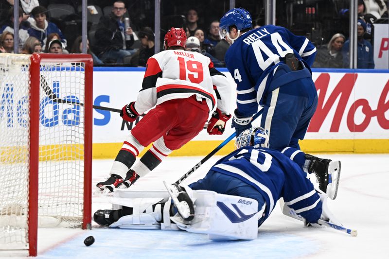 Mar 20, 2026; Toronto, Ontario, CAN;  Carolina Hurricanes defenseman K'Andre Miller (19) skates away to celebrate after scoring a goal past Toronto Maple Leafs goalie Joseph Woll (60) as defenseman Morgan Rielly (44) trails the play in the second period at Scotiabank Arena. Mandatory Credit: Dan Hamilton-Imagn Images