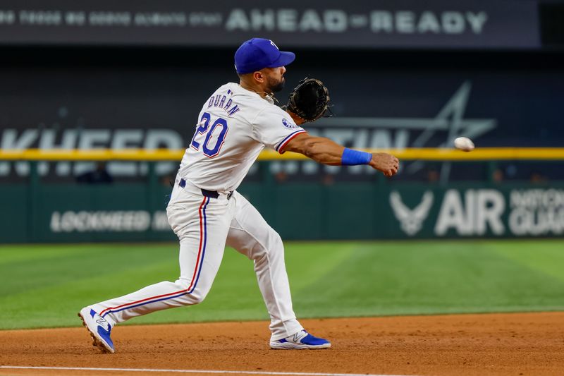 Sep 21, 2024; Arlington, Texas, USA; Texas Rangers third base Ezequiel Duran (20) fields a ground ball and turns a double play during the fifth inning against the Seattle Mariners at Globe Life Field. Mandatory Credit: Andrew Dieb-Imagn Images