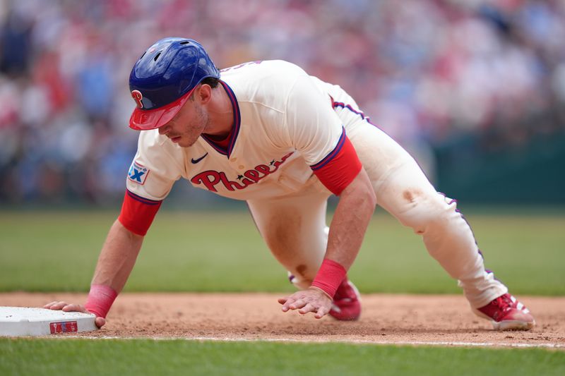 May 18, 2025; Philadelphia, Pennsylvania, USA; Philadelphia Phillies outfielder Max Kepler (17) dives back to first against the Pittsburgh Pirates in the fifth inning at Citizens Bank Park. Mandatory Credit: Kyle Ross-Imagn Images