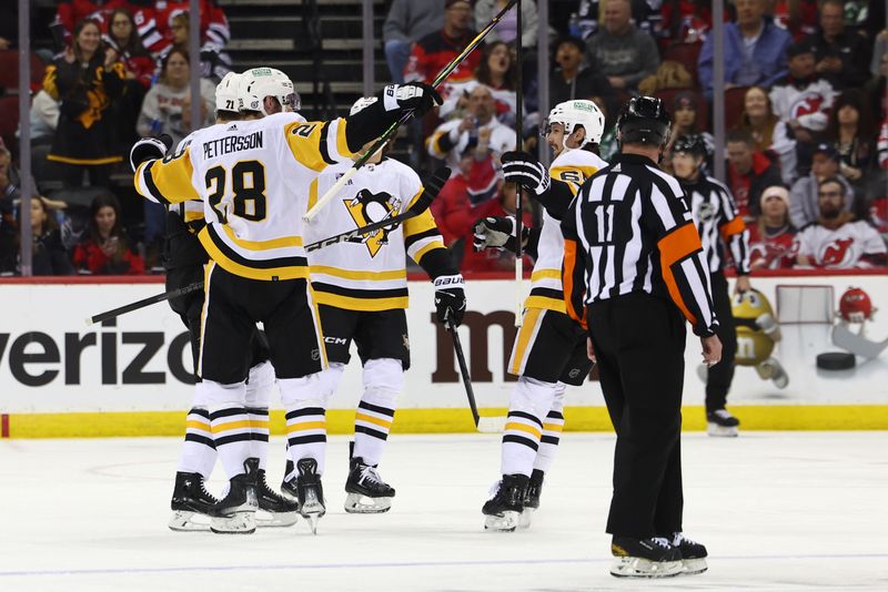 Mar 19, 2024; Newark, New Jersey, USA; Pittsburgh Penguins defenseman Marcus Pettersson (28) celebrates his goal against the New Jersey Devils during the second period at Prudential Center. Mandatory Credit: Ed Mulholland-USA TODAY Sports