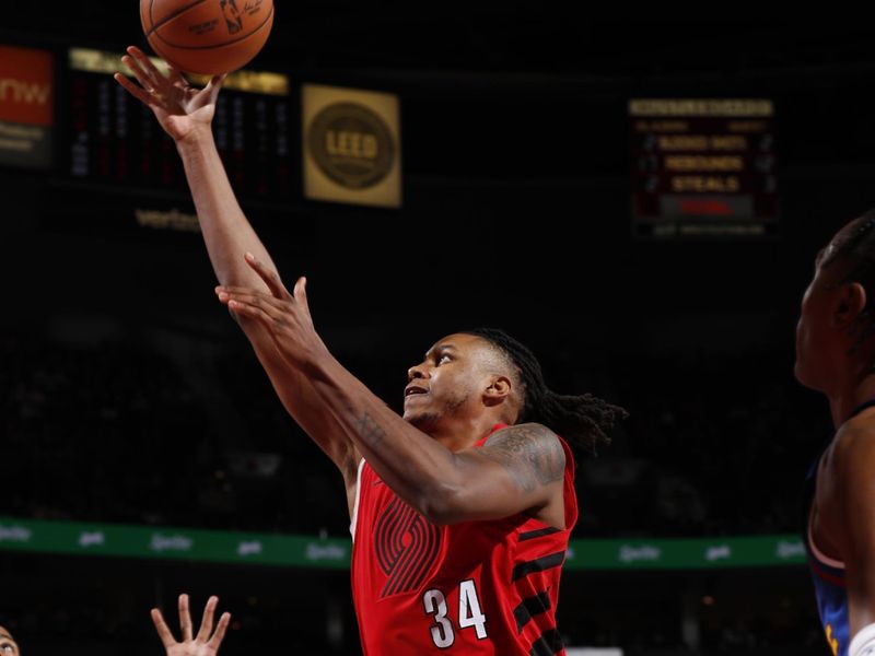 PORTLAND, OR - MARCH 23: Jabari Walker #34 of the Portland Trail Blazers drives to the basket during the game against the Denver Nuggets on March 23, 2024 at the Moda Center Arena in Portland, Oregon. NOTE TO USER: User expressly acknowledges and agrees that, by downloading and or using this photograph, user is consenting to the terms and conditions of the Getty Images License Agreement. Mandatory Copyright Notice: Copyright 2024 NBAE (Photo by Cameron Browne/NBAE via Getty Images)