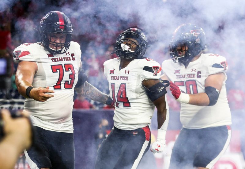 Sep 4, 2021; Houston, Texas, USA; Texas Tech Red Raiders running back Xavier White (14) celebrates with teammates after scoring a touchdown against the Houston Cougars during the fourth quarter at NRG Stadium. Mandatory Credit: Troy Taormina-USA TODAY Sports