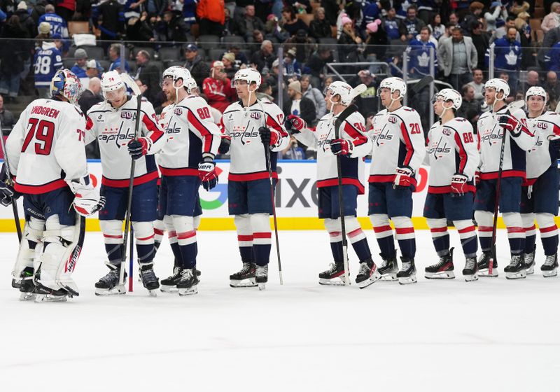 Dec 6, 2024; Toronto, Ontario, CAN; Washington Capitals defenseman John Carlson (74) celebrates the win with goaltender Charlie Lindgren (79) against the Toronto Maple Leafs at the end of the third period at Scotiabank Arena. Mandatory Credit: Nick Turchiaro-Imagn Images