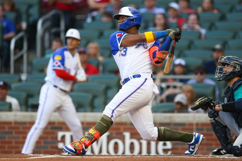 May 20, 2023; Atlanta, Georgia, USA; Atlanta Braves right fielder Ronald Acuna Jr. (13) hits a single against the Seattle Mariners in the first inning at Truist Park. Mandatory Credit: Brett Davis-USA TODAY Sports