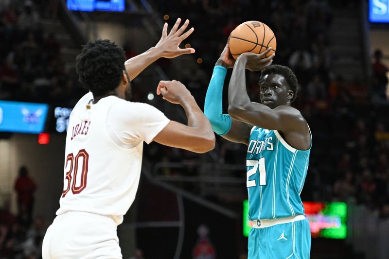 CLEVELAND, OHIO - APRIL 14: JT Thor #21 of the Charlotte Hornets shoots a three-point basket against Damian Jones #30 of the Cleveland Cavaliers during the second half at Rocket Mortgage Fieldhouse on April 14, 2024 in Cleveland, Ohio. NOTE TO USER: User expressly acknowledges and agrees that, by downloading and or using this photograph, User is consenting to the terms and conditions of the Getty Images License Agreement. (Photo by Nick Cammett/Getty Images)