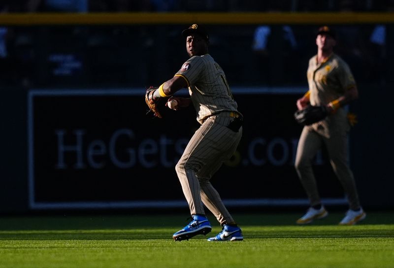 Aug 16, 2024; Denver, Colorado, USA; San Diego Padres outfielder Jurickson Profar (10) fields the ball in the first inning against the Colorado Rockies at Coors Field. Mandatory Credit: Ron Chenoy-USA TODAY Sports