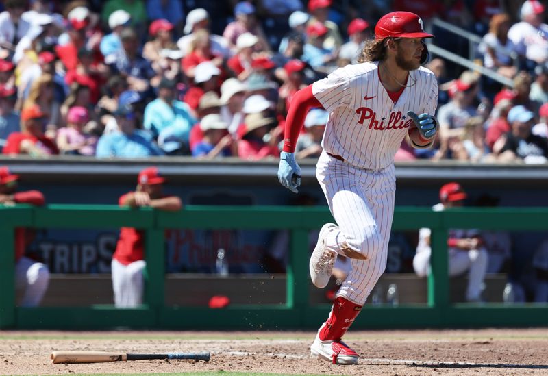 Mar 19, 2025; Clearwater, Florida, USA;  Philadelphia Phillies third base Alec Bohm (28) singles during the sixth inning against the New York Yankees at BayCare Ballpark. Mandatory Credit: Kim Klement Neitzel-Imagn Images