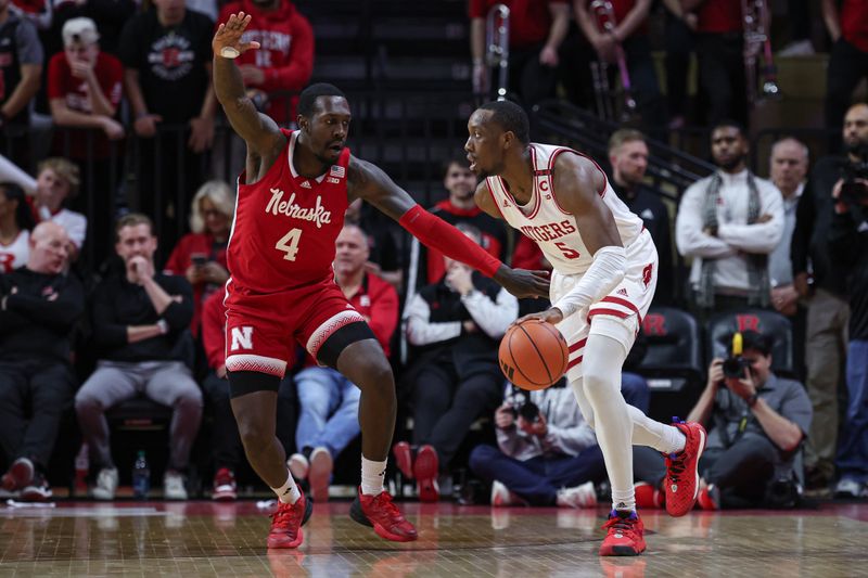 Jan 17, 2024; Piscataway, New Jersey, USA; Rutgers Scarlet Knights forward Aundre Hyatt (5) dribbles against Nebraska Cornhuskers forward Juwan Gary (4) during the first half at Jersey Mike's Arena. Mandatory Credit: Vincent Carchietta-USA TODAY Sports