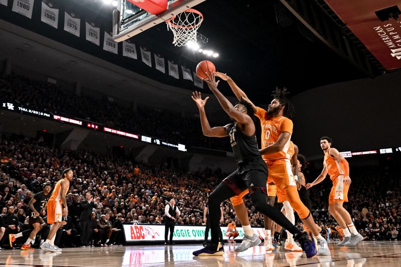 Feb 21, 2023; College Station, Texas, USA; Tennessee Volunteers forward Jonas Aidoo (0) fouls Texas A&M Aggies forward Julius Marble (34) during the second half at Reed Arena. Mandatory Credit: Maria Lysaker-USA TODAY Sports