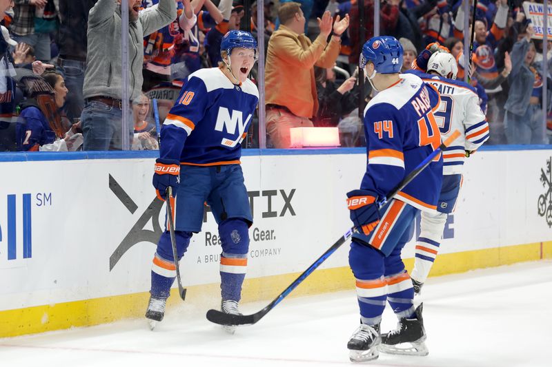 Dec 19, 2023; Elmont, New York, USA; New York Islanders right wing Simon Holmstrom (10) celebrates his short handed goal against the Edmonton Oilers with center Jean-Gabriel Pageau (44) during the second period at UBS Arena. Mandatory Credit: Brad Penner-USA TODAY Sports