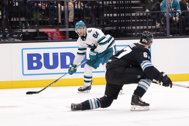 Oct 28, 2024; Salt Lake City, Utah, USA;  San Jose Sharks defenseman Jan Rutta (84) tries to shoot the puck past Utah Hockey Club left wing Lawson Crouse (67) during the third period at Delta Center. Mandatory Credit: Chris Nicoll-Imagn Images