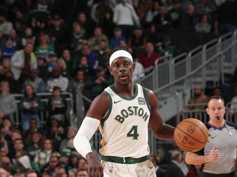 MILWAUKEE, WI - JANUARY 11:  Jrue Holiday #4 of the Boston Celtics handles the ball during the game  on January 11, 2024 at the Fiserv Forum Center in Milwaukee, Wisconsin. NOTE TO USER: User expressly acknowledges and agrees that, by downloading and or using this Photograph, user is consenting to the terms and conditions of the Getty Images License Agreement. Mandatory Copyright Notice: Copyright 2024 NBAE (Photo by Gary Dineen/NBAE via Getty Images).