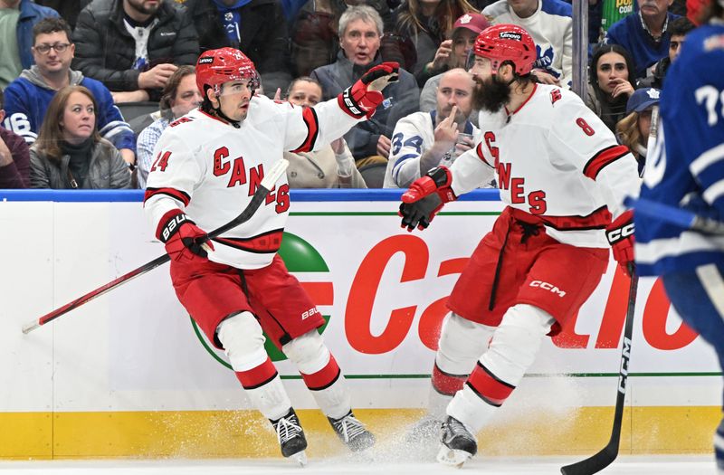 Dec 30, 2023; Toronto, Ontario, CAN; Carolina Hurricanes forward Seth Jarvis (24) celebrates with defenseman Brett Burns (8) after scoring a goal against the Toronto Maple Leafs in the second period at Scotiabank Arena. Mandatory Credit: Dan Hamilton-USA TODAY Sports