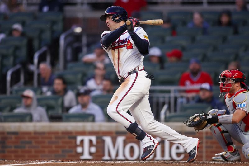 Apr 10, 2025; Atlanta, Georgia, USA; Atlanta Braves third baseman Austin Riley (27) hits a single against the Philadelphia Phillies in the third inning at Truist Park. Mandatory Credit: Brett Davis-Imagn Images